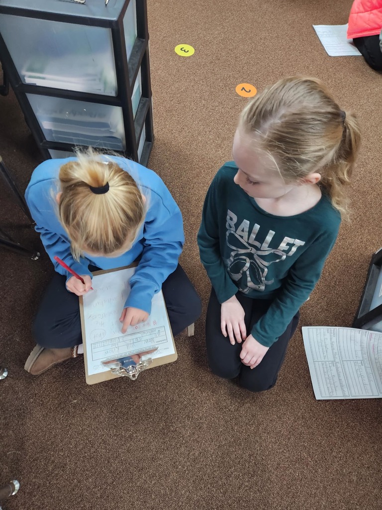students working together using clipboards