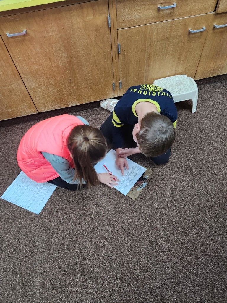 students working together using clipboards