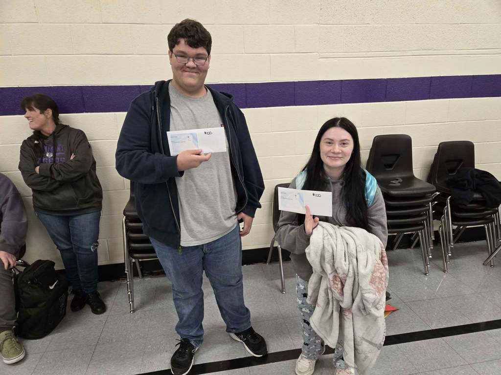 students posing with certificates