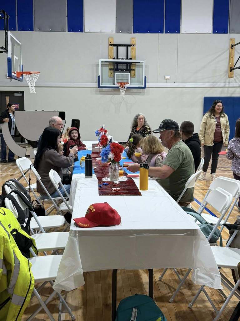 students eating donuts with veterans