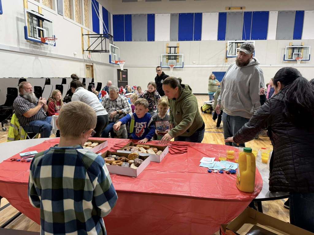 students eating donuts with veterans