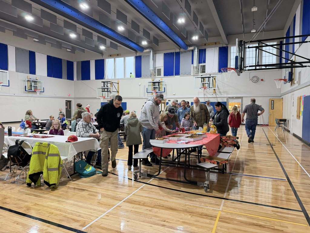 students eating donuts with veterans