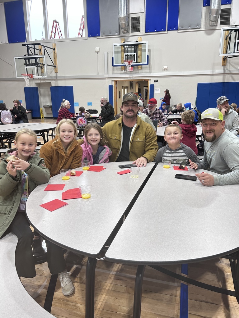students eating donuts with veterans