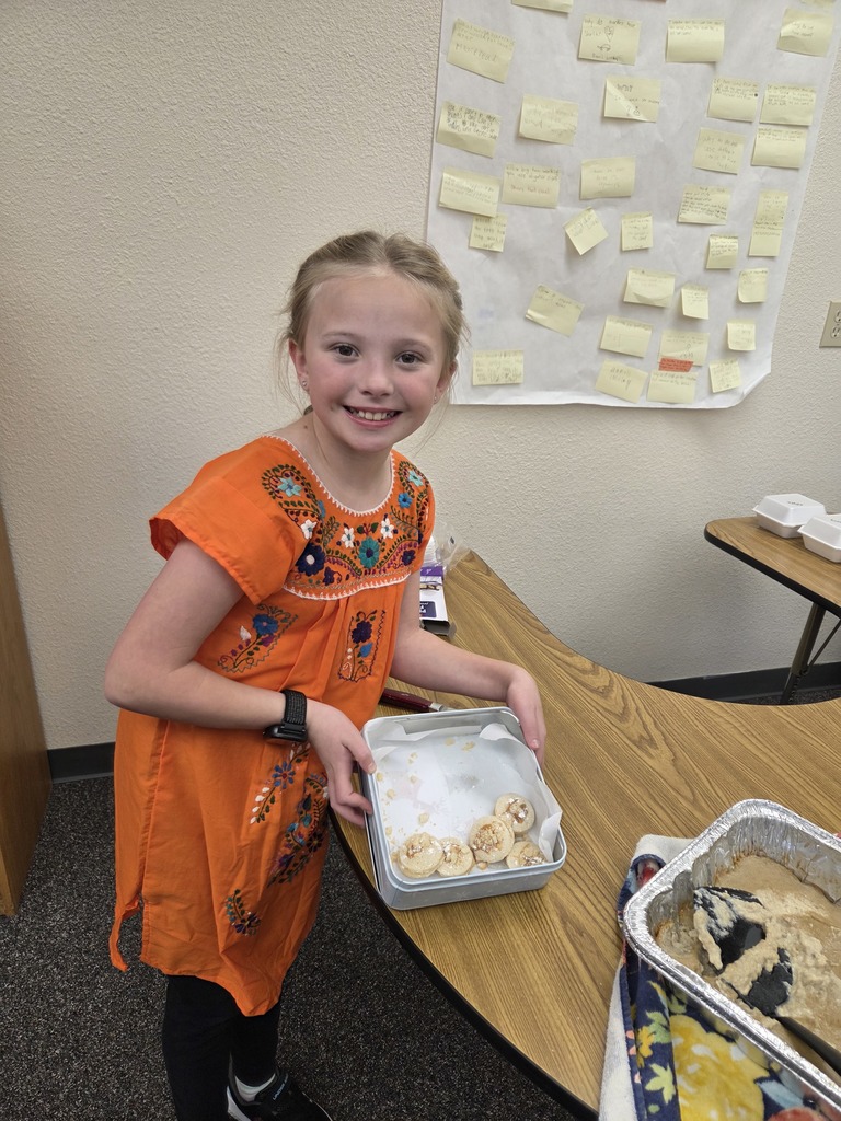students with the dish they made
