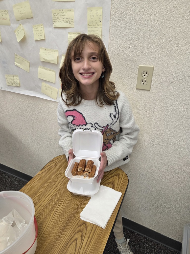students with the dish they made