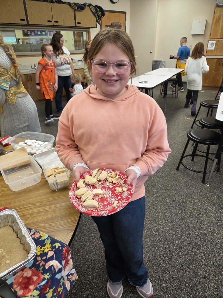 students with the dish they made
