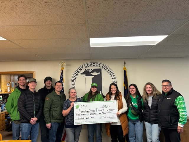 people holding a big check