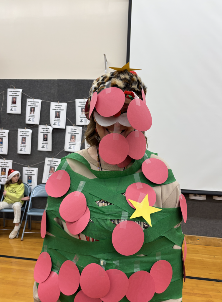 students dressing their teachers up like Christmas trees
