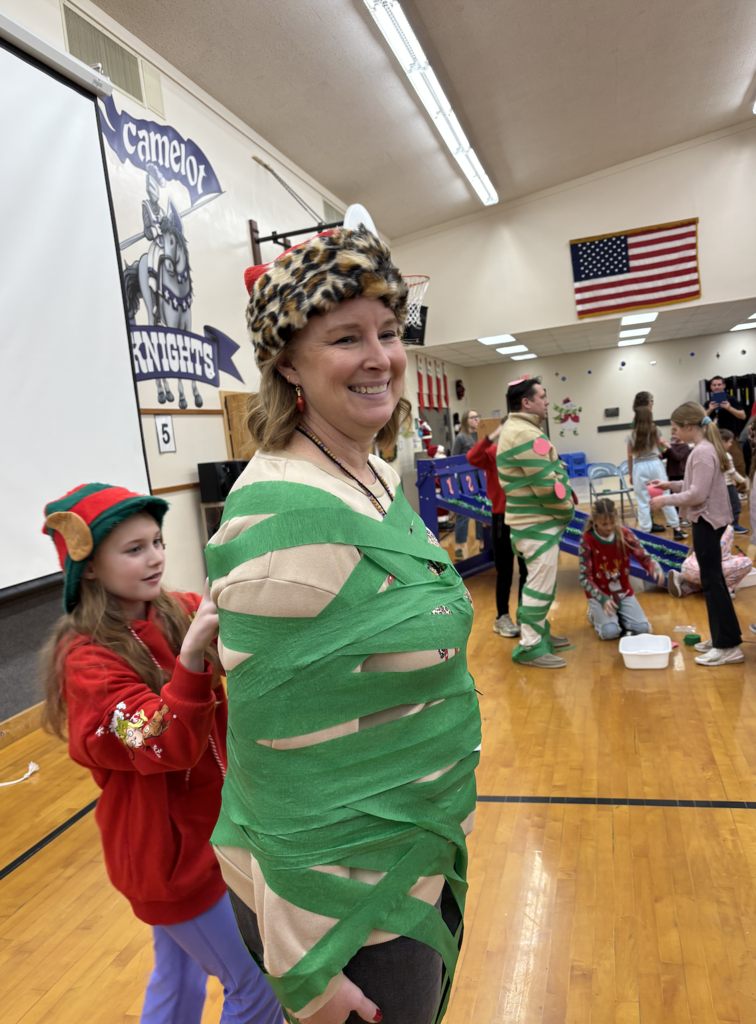 students dressing their teachers up like Christmas trees