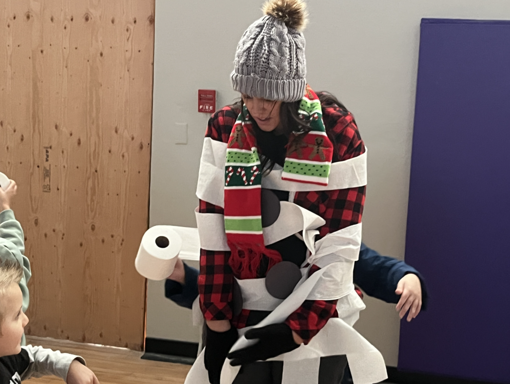students dressing their teachers up like snowmen