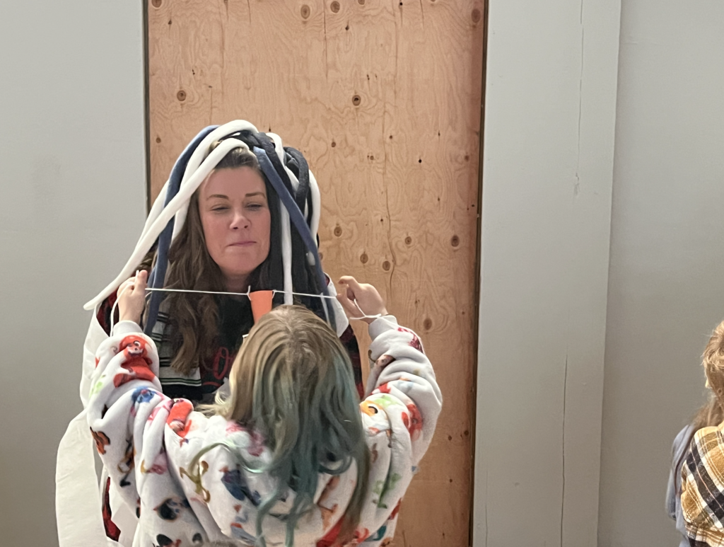 students dressing their teachers up like snowmen