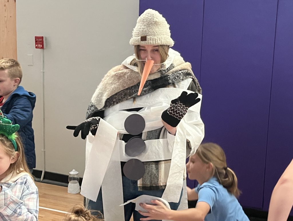 students dressing their teachers up like snowmen
