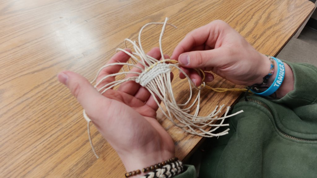 students learning to weave
