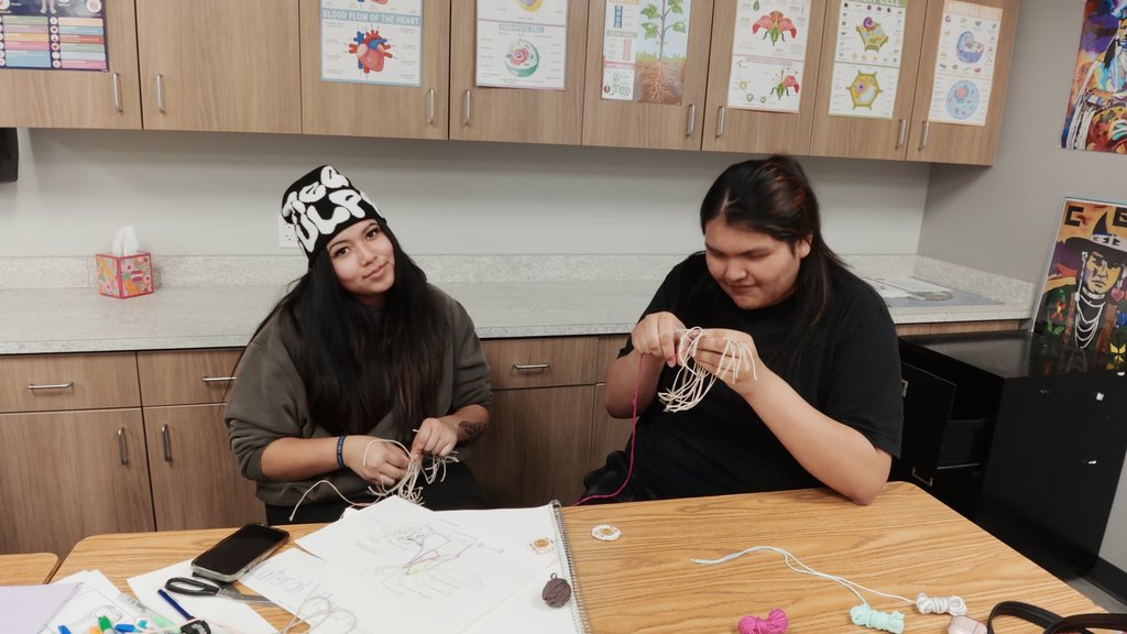 students learning to weave