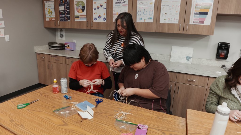 students learning to weave