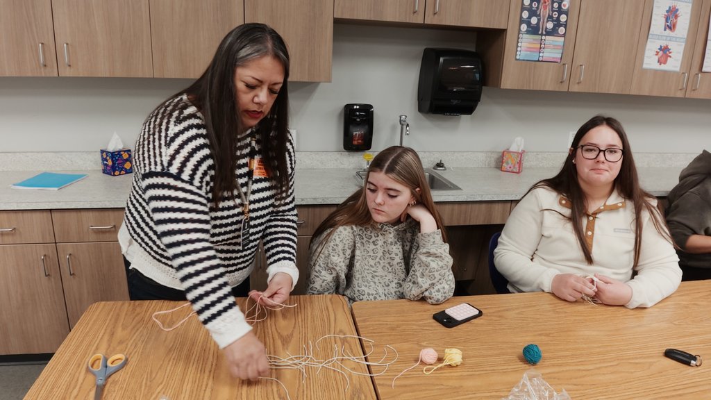 students learning to weave