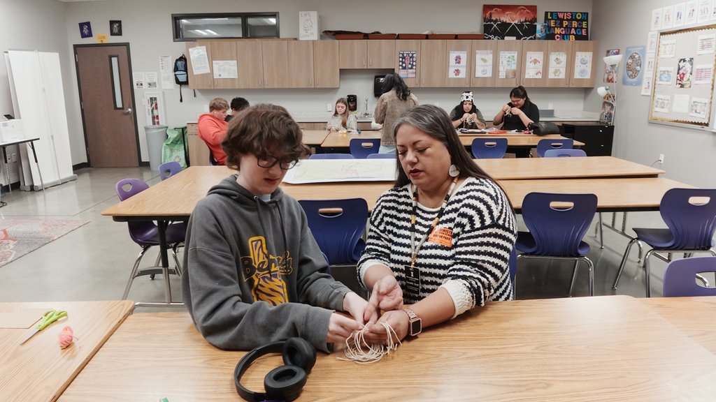 students learning to weave