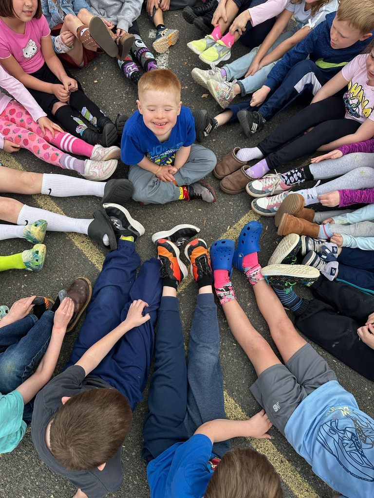 a circle of people wearing mismatched socks