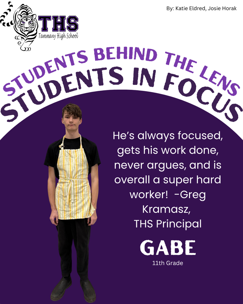 student in  black shirt black pants, black shoes, and yellow apron