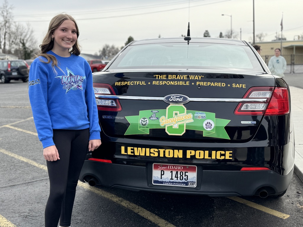Avery standing behind the car