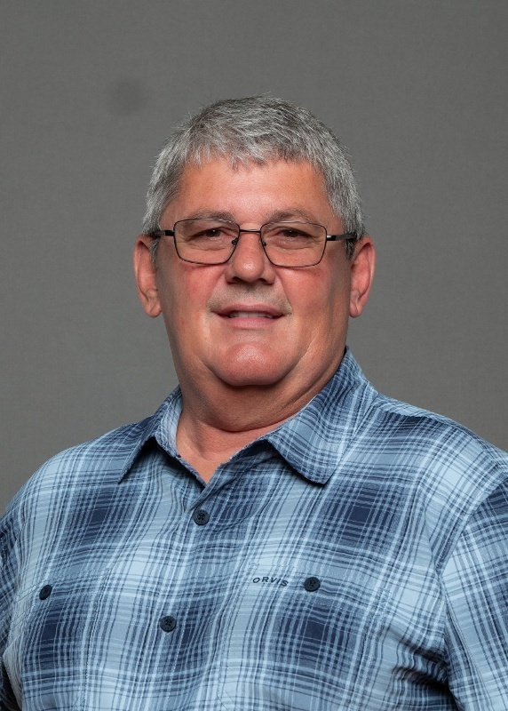 man  with grey hair and a blue plaid