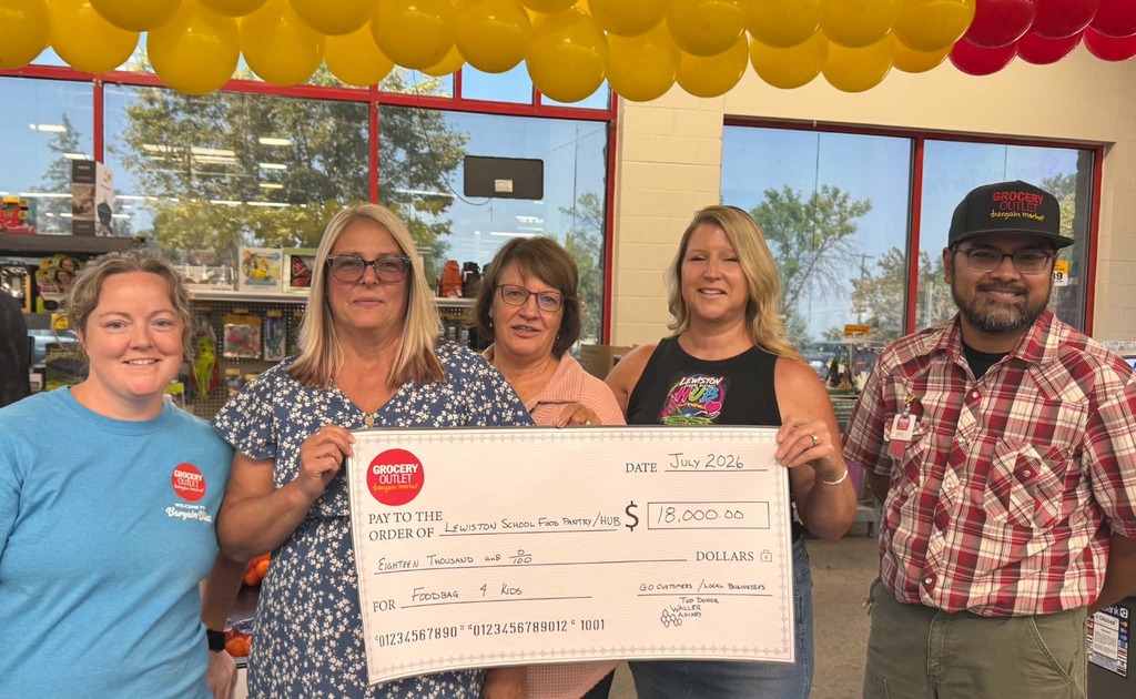 5 people holding a ceremonial check for $18,000
