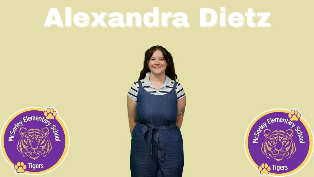 woman with brown hair in a striped shirt and blue jumpsuit
