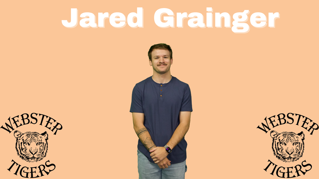 man with brown hair, brown mustache, blue shirt, grey pants