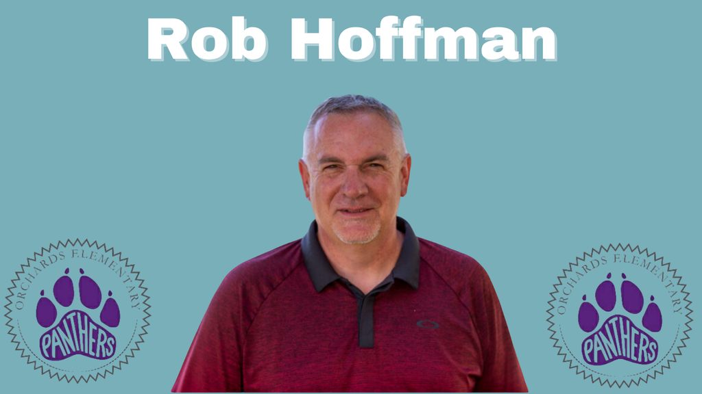 man in a maroon shirt, he has short grey hair