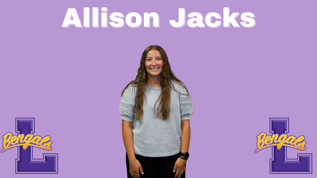Allison has long brown hair, black pants, and grey shirt