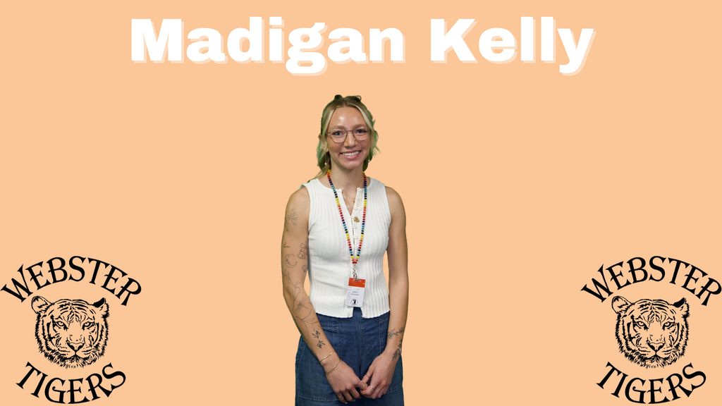 Madigan has short blonde hair, white tank top, blue jeans