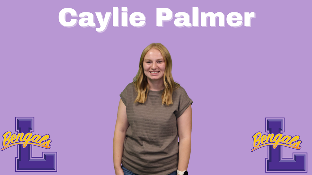 Caylie has shoulder length strawberry blonde hair and a tan top on