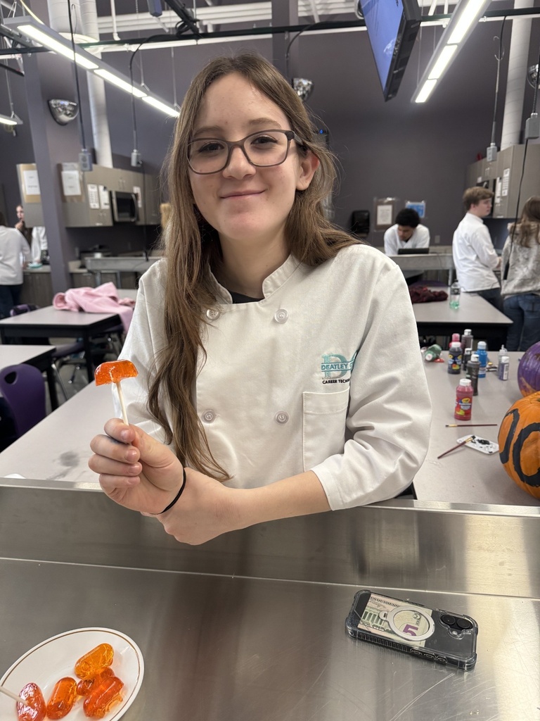 student holding a lollipop