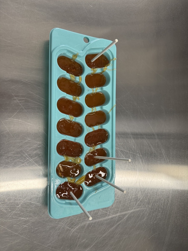 students pouring lollipops