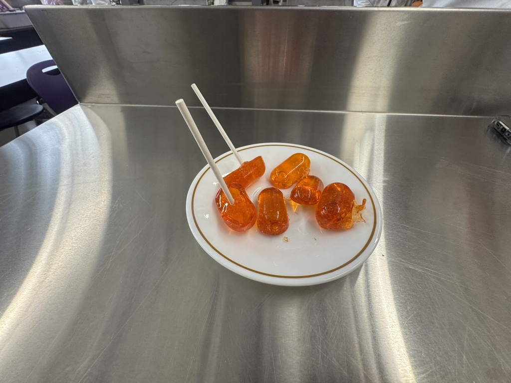 students pouring lollipops
