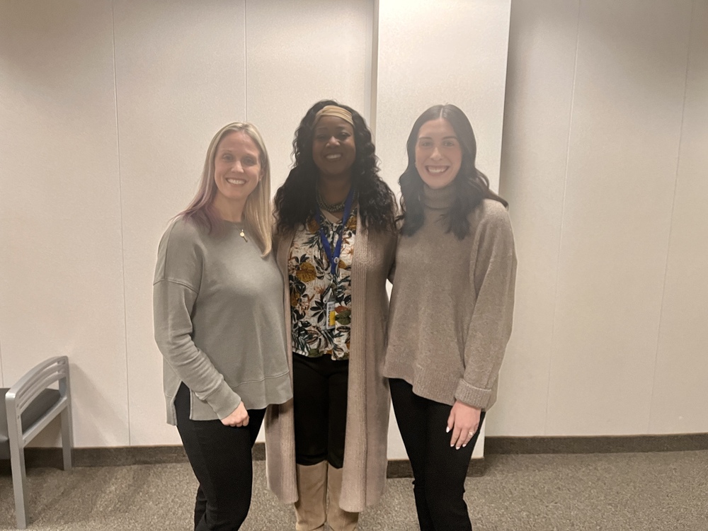 Dr. Hardy stands with Kalie Radonavitch and Michelle Davis at the Davidson County Commissioners meeting, representing Lexington City Schools.
