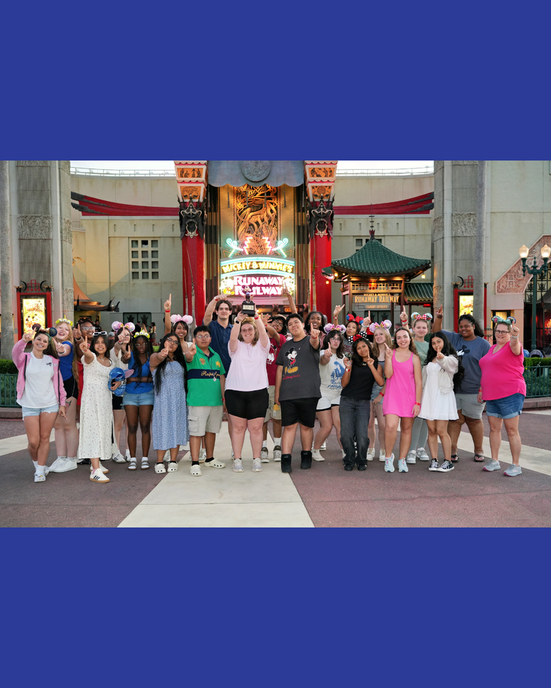 Group of Lexington City Schools chorus students posing together during their trip to Walt Disney World, celebrating their Best in Class award and Superior rating at a choral competition.