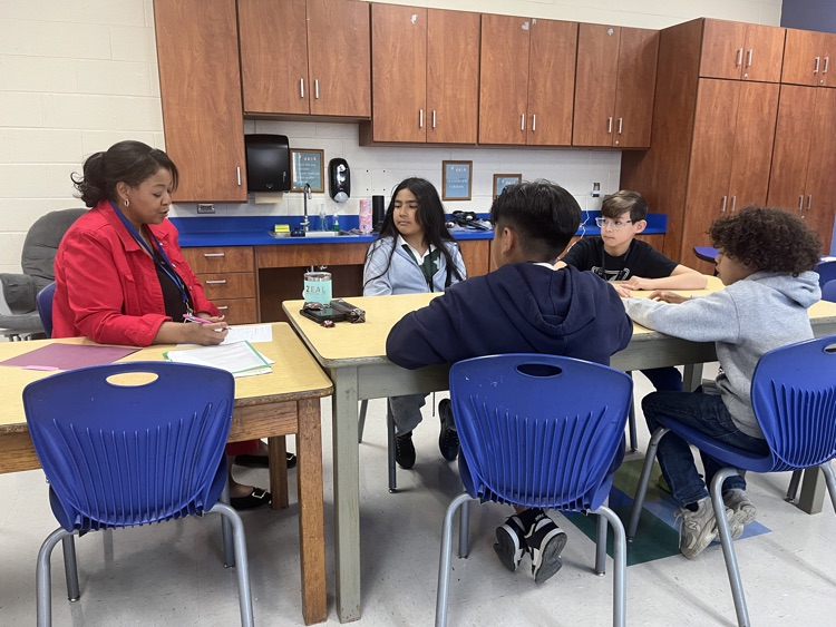Dr. Hardy seated at a table with Charles England Elementary students during the first Student Advisory meeting of the school year.