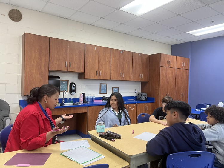 Dr. Hardy seated at a table with Charles England Elementary students during the first Student Advisory meeting of the school year.