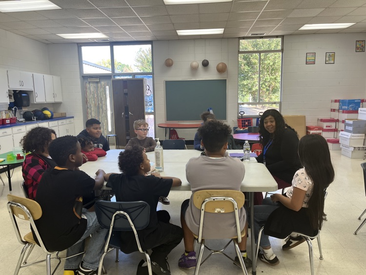 “Dr. Hardy listening  intently to a Southwest Global Academy student sharing feedback during the Student Advisory.”