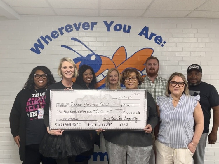 Amy Tarr in a group photo donating $2000 to Pickett Elementary School. 