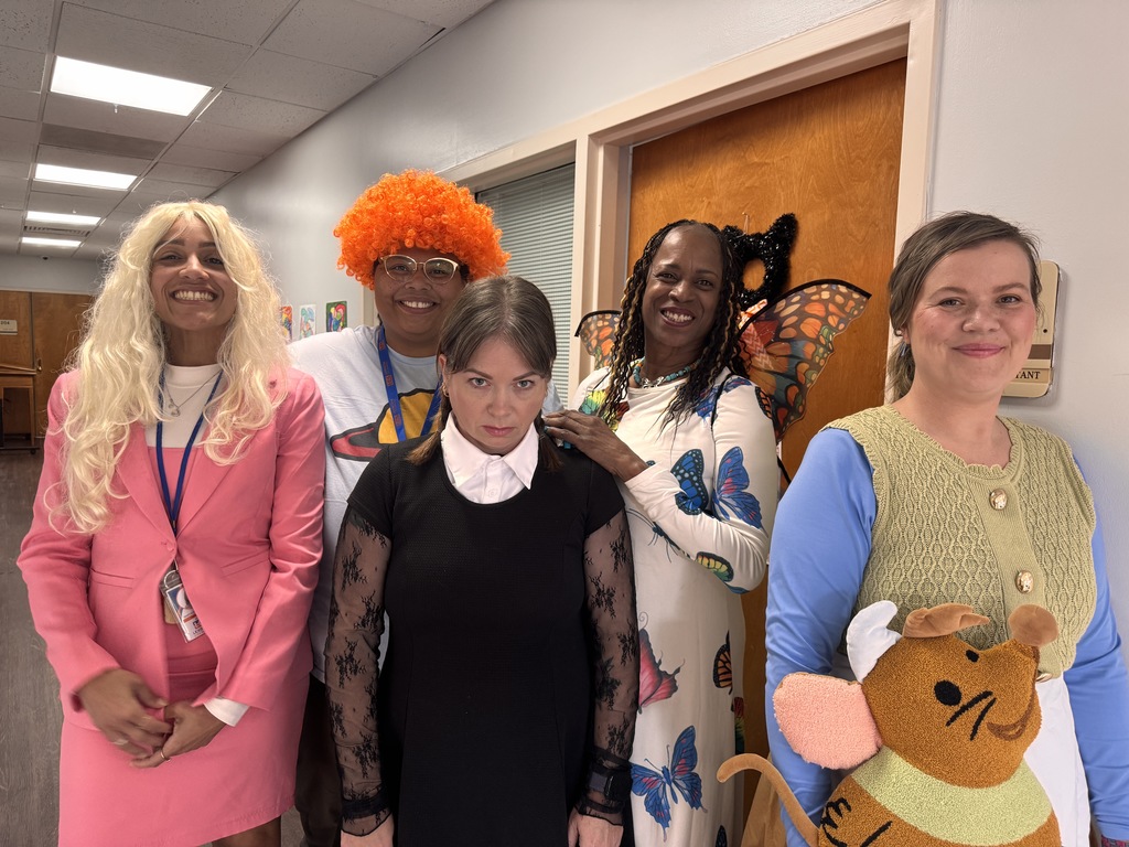 Central Office staff dressed in costumes smiling and celebrating the final day of FA-BOO-LOUS Week.