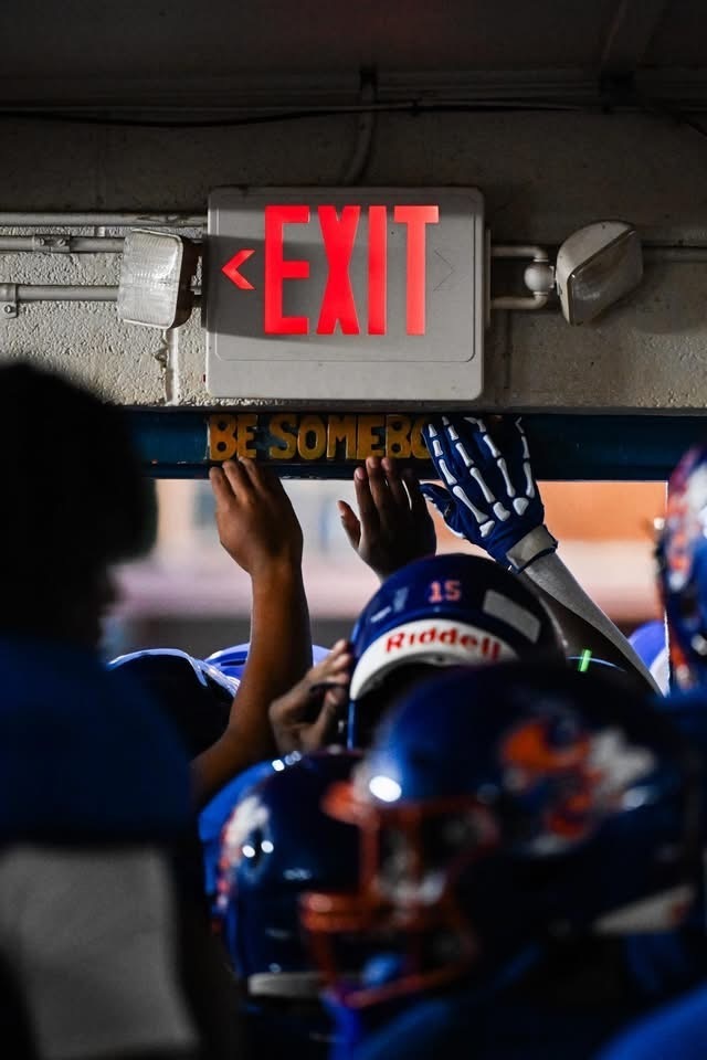 LSHS athletes touching the be somebody sign.