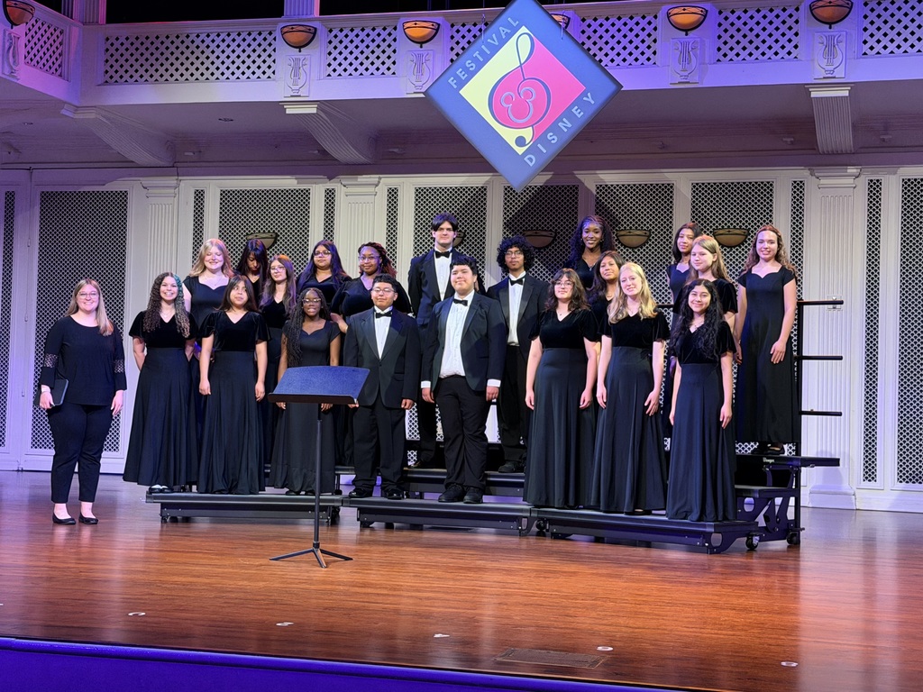 Group of Lexington City Schools chorus students posing together during their trip to Walt Disney World, celebrating their Best in Class award and Superior rating at a choral competition.
