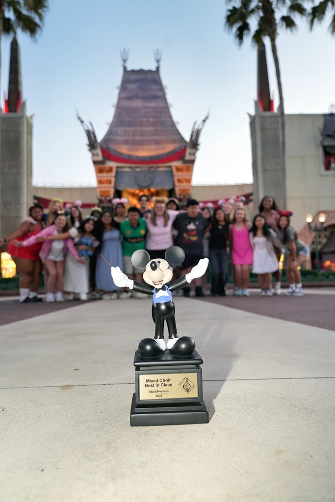 Group of Lexington City Schools chorus students posing together during their trip to Walt Disney World, celebrating their Best in Class award and Superior rating at a choral competition.