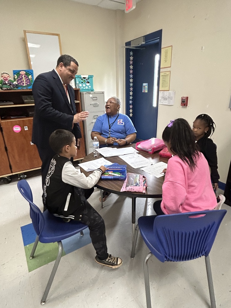 Dr. Ron Anthony visiting multiple schools across the district on his first day, interacting with students and staff in classrooms and hallways.