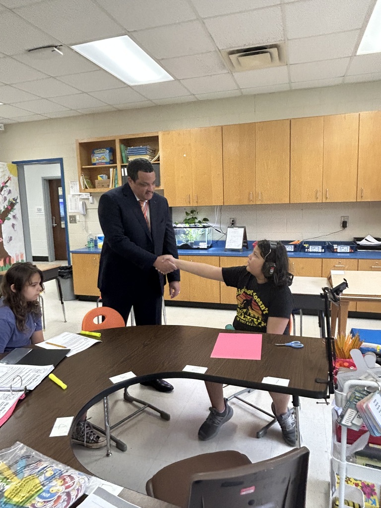 Dr. Ron Anthony visiting multiple schools across the district on his first day, interacting with students and staff in classrooms and hallways.