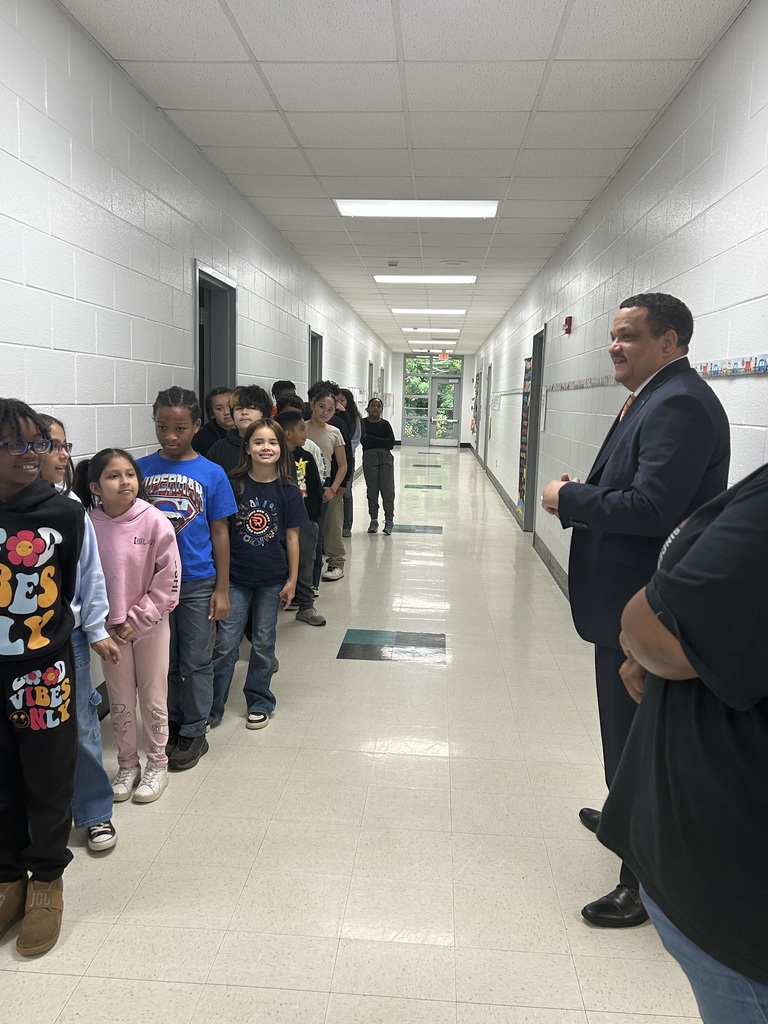Dr. Ron Anthony visiting multiple schools across the district on his first day, interacting with students and staff in classrooms and hallways.