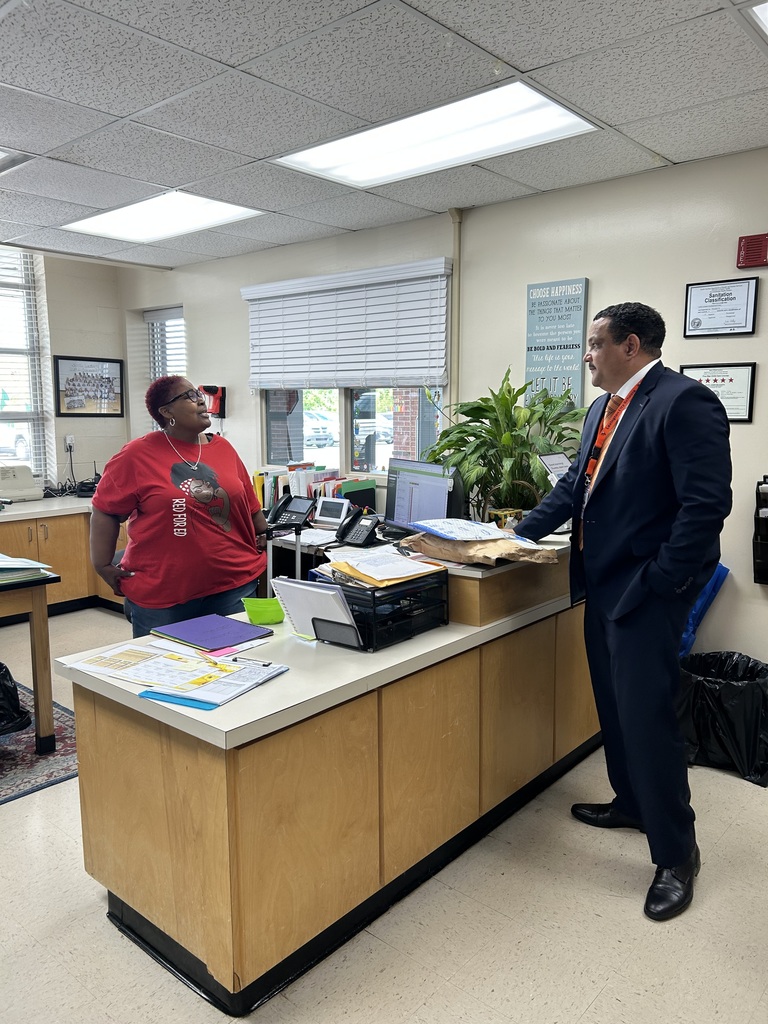 Dr. Ron Anthony visiting multiple schools across the district on his first day, interacting with students and staff in classrooms and hallways.