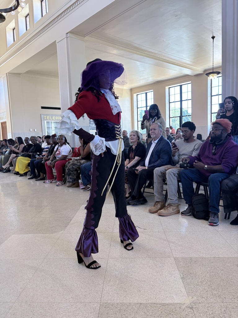Ahmad Williamson and Julian Stockton work on fashion designs and showcase their completed pieces at Winston Salem Fashion Week.
